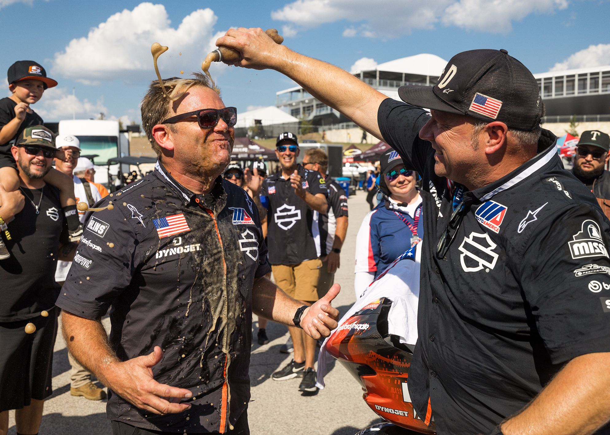 Harley-Davidson Factory Racing Lead Crew Chief Bjorn Christensen gets doused with soda by his teammate after a race win.