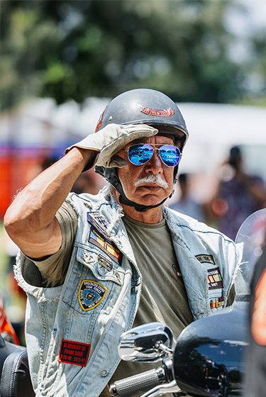 Harley Davidson rider salutes a US service member 