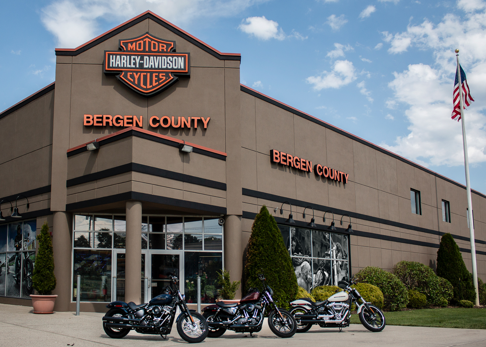 The exterior of Bergen Harley-Davidson with 3 motorcycles parked in the foreground.