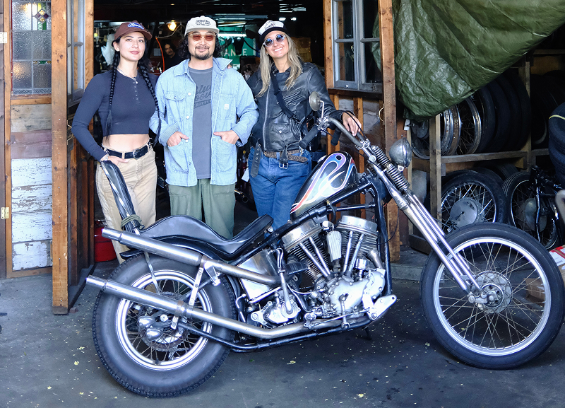 The authors standing with Taka outside of his garage beside a custom chopper with flame tank paint