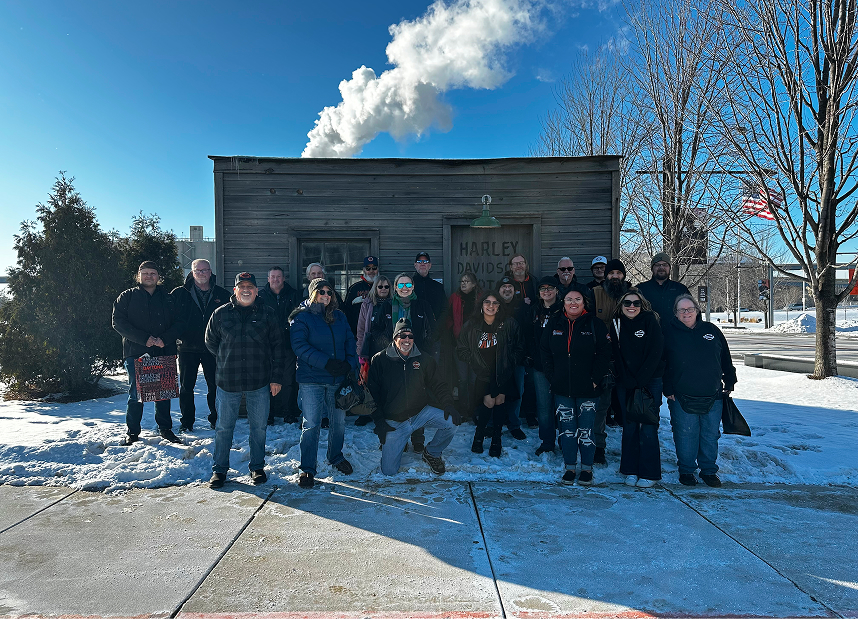 A photo of the Kegel family in front of a recreation of the original Harley-Davidson shed at the Harley-Davidson Museum in Milwaukee