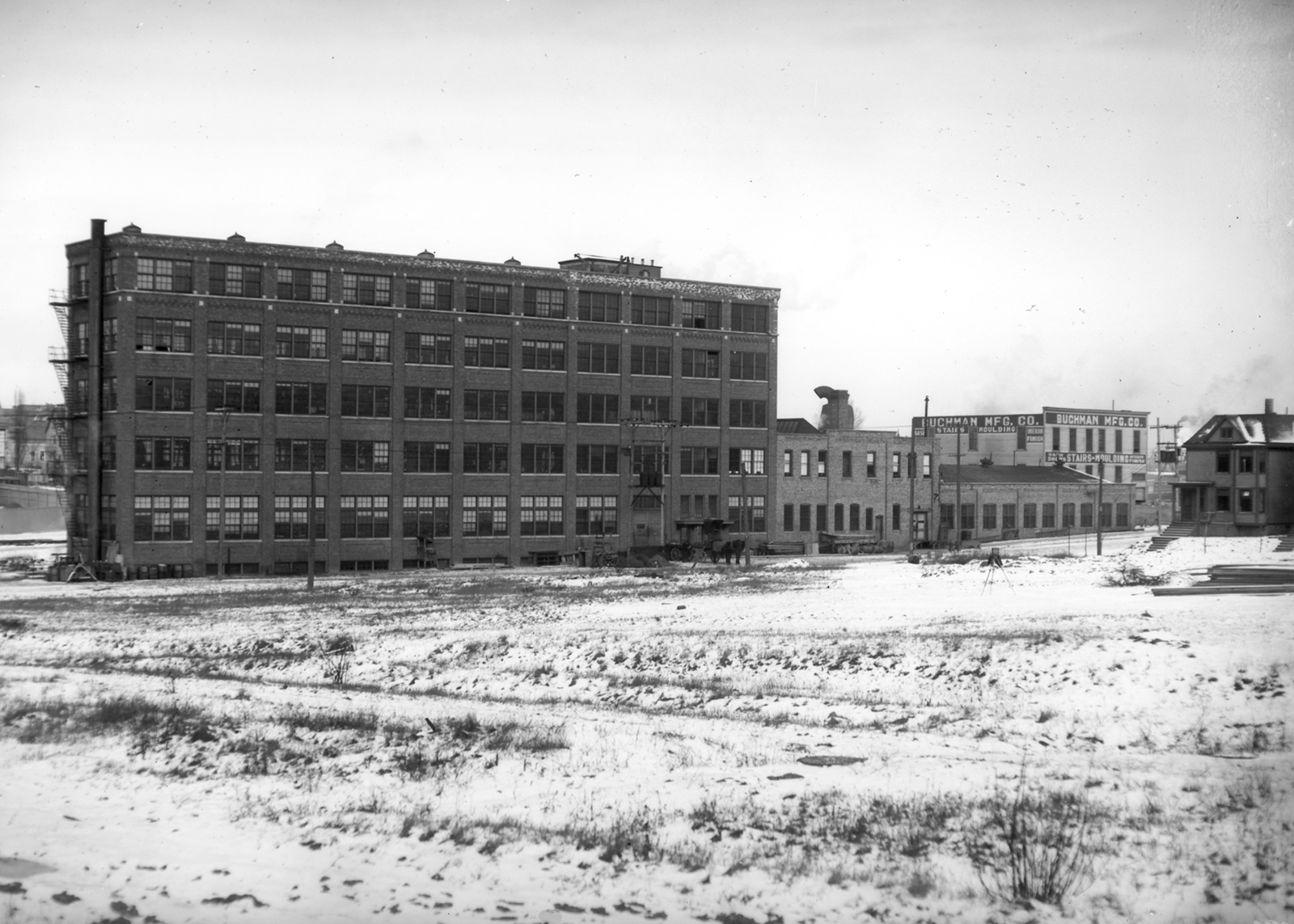 A black and white photo of a large brick warehouse