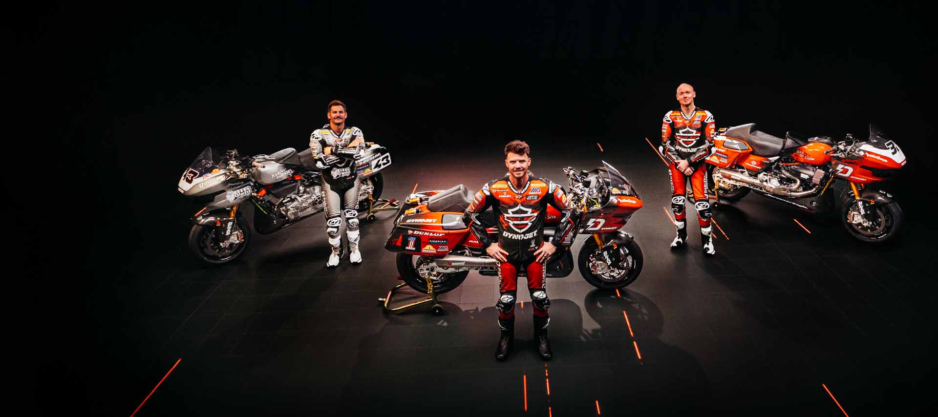 three h-d racers together with their motorcycles
