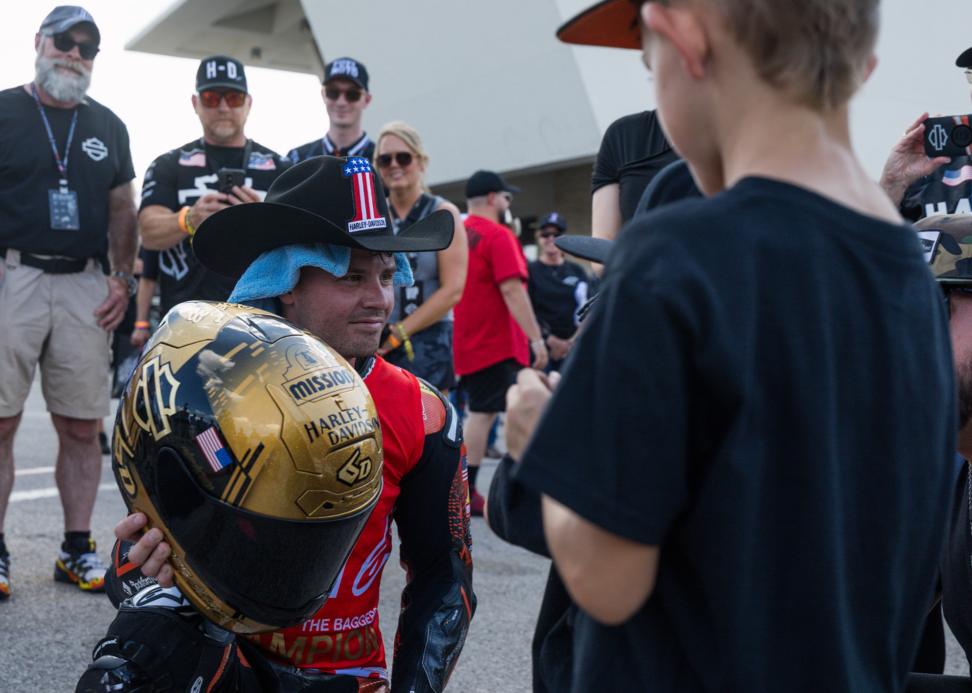 Kyle Wyman shows his custom gold helmet to young fans after winning the 2025 King Of The Baggers championship.