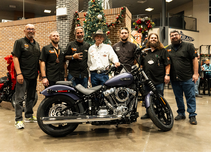 Gold Tier winner Andrew Peterson stands with his new 2025 Street Bob surrounded by Rockstar Harley-Davidson staff