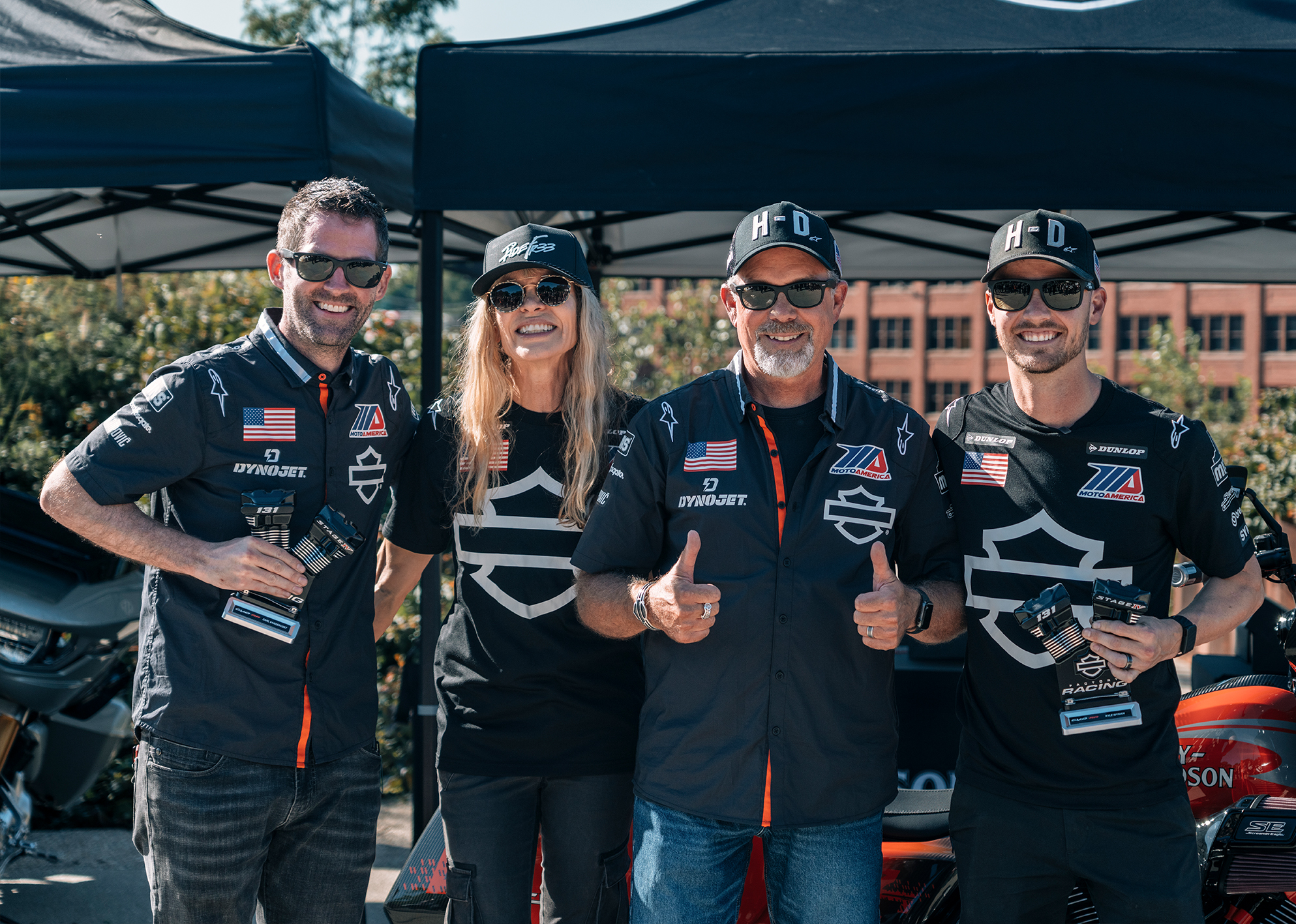 Harley-Davidson Factory Racing Lead Carl Vandervort poses with Bill and Karen Davidson and Kyle Wyman.