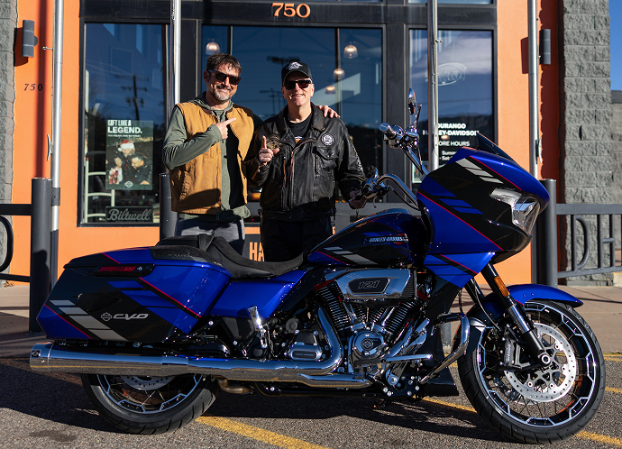 Black & Orange Tier winner Jeff Guynes stands with another person and his new 2025 CVO Road Glide at Durango Harley-Davidson