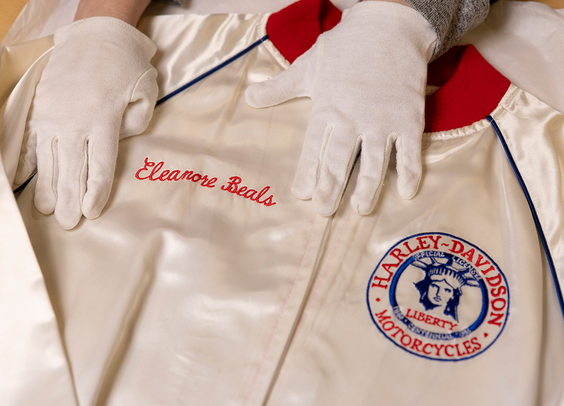 A white satin jacket embroidered with the name Eleanore Beals and Liberty Centennial 1986 emblem