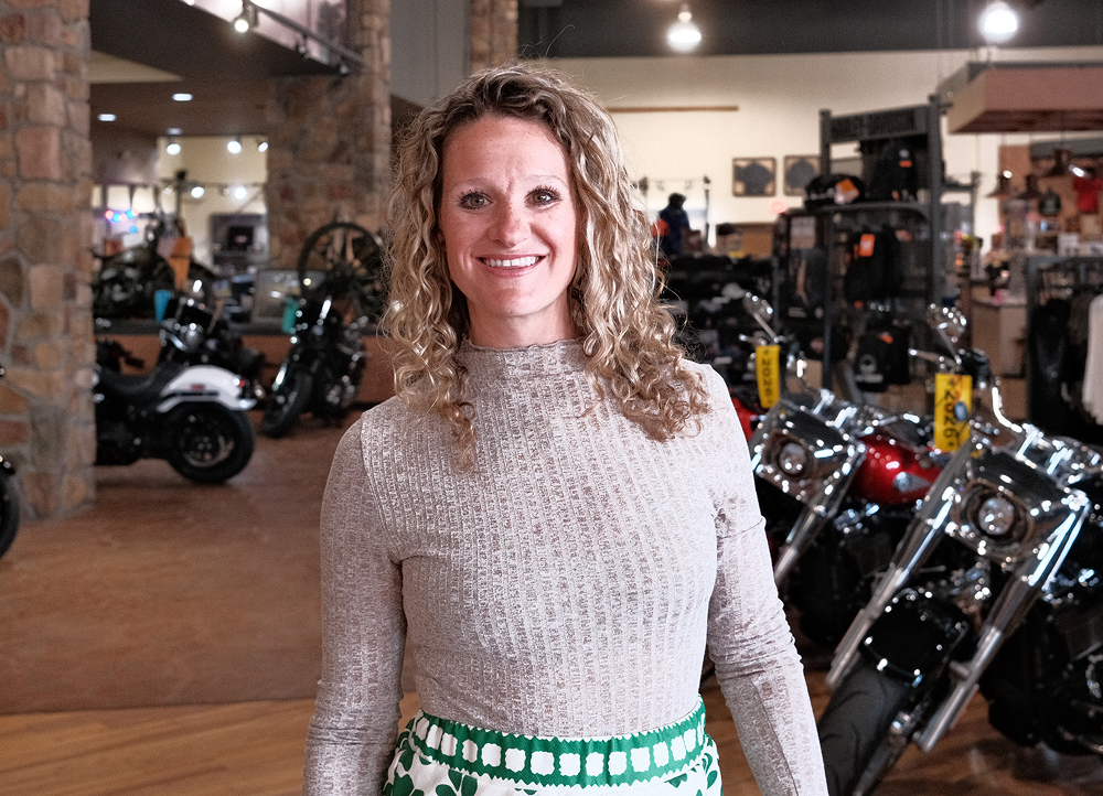Bumpus Harley-Davidson dealership staff member smiling for a photo inside the showroom