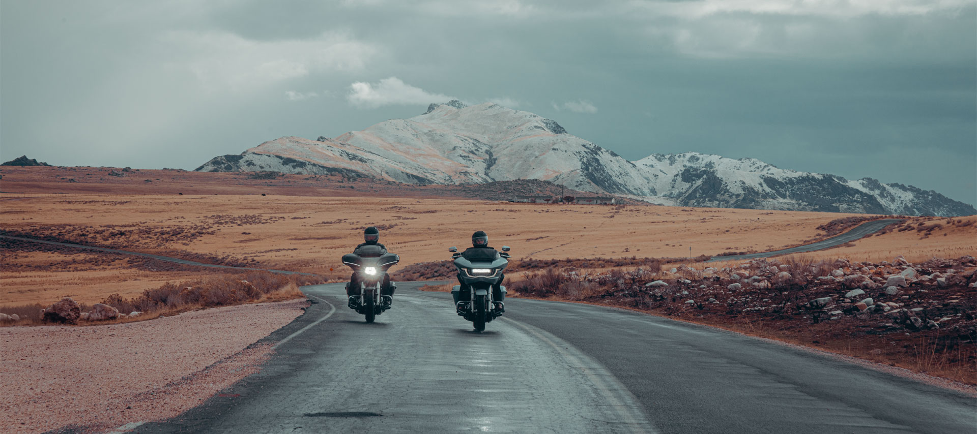 Riders on an open mountain road