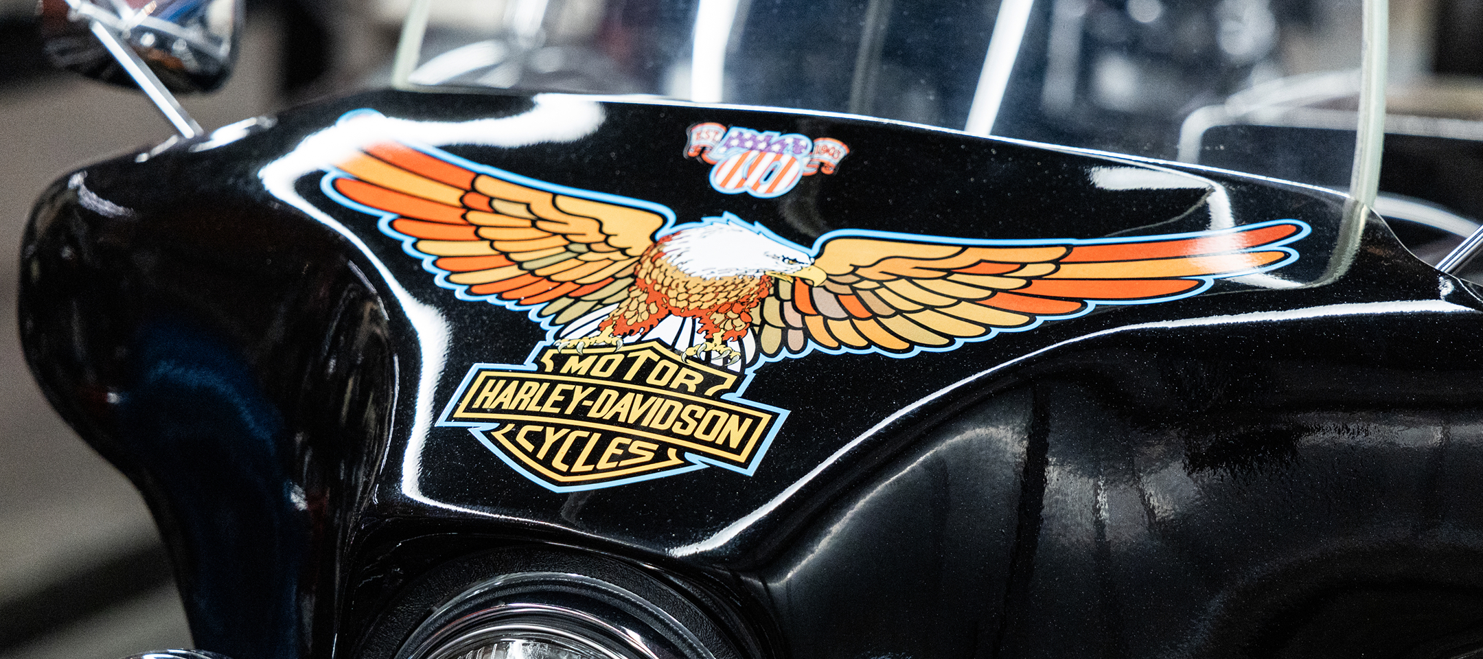 Close-up of a black 1976 Harley-Davidson front fairing featuring the iconic eagle and Bar & Shield graphic