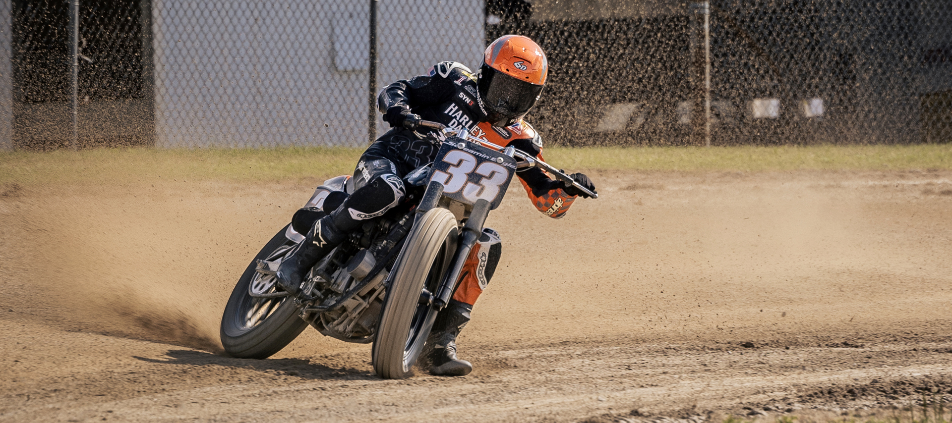 Kyle Wyman rides sideways on a dirt flat track