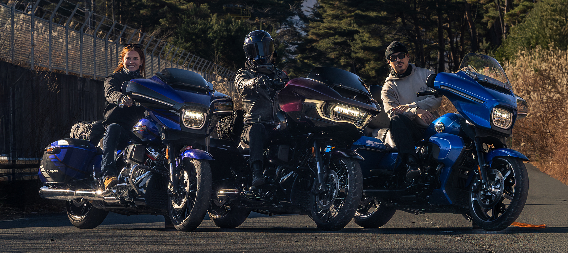 Kalen Thorien, VonGasphalt, and David Chang pose on their Harley-Davidson touring motorcycles with Mt. Fuji in the background