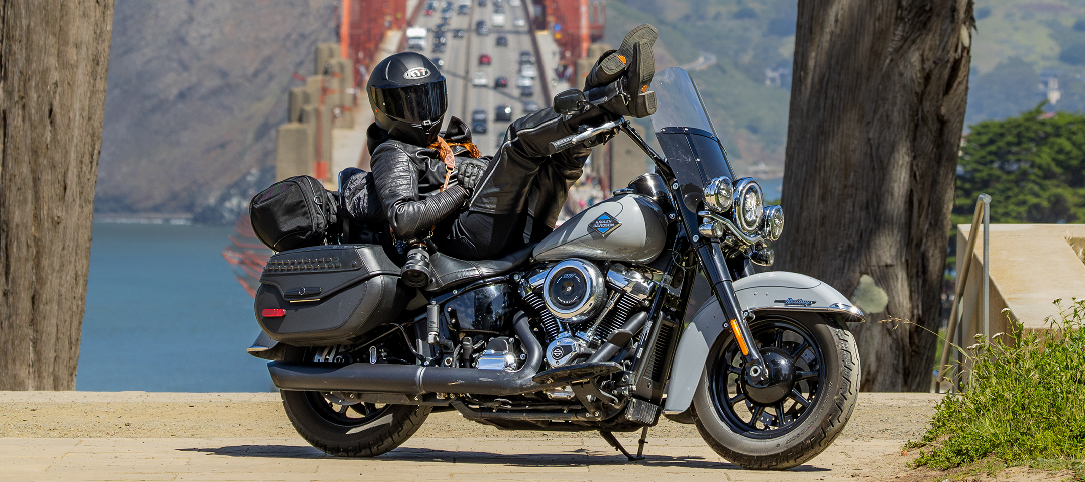 Motorcycle parked roadside with rider leaning back on seat and Golden Gate Bridge in background