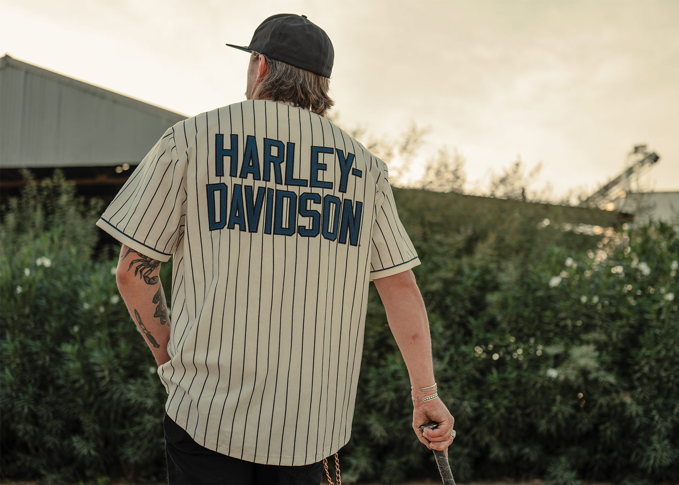 Man in H-d white with black pinstripes baseball jersey