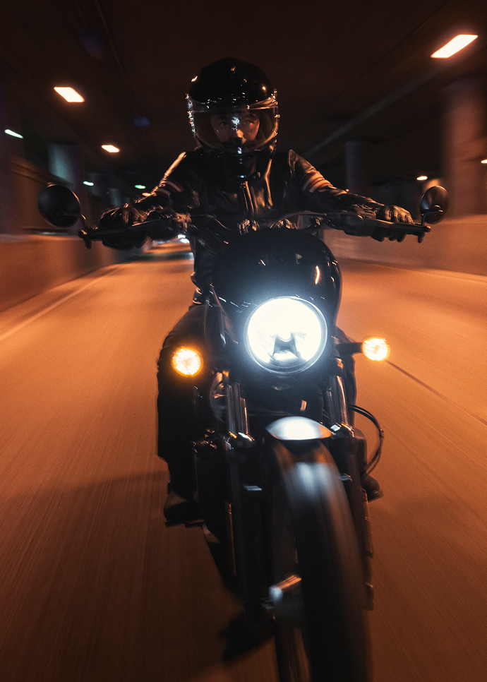 Nightster Special rider on road at night