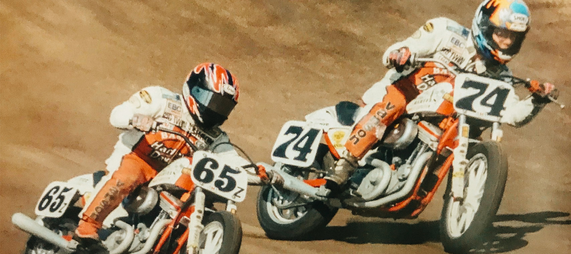 A vintage photo of two Bartel’s Harley-Davidson riders racing on a dirt flat track.