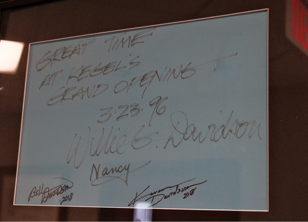 A framed handwritten note signed by Willie G. Davidson hangs on the wall at Kegel Harley-Davidson