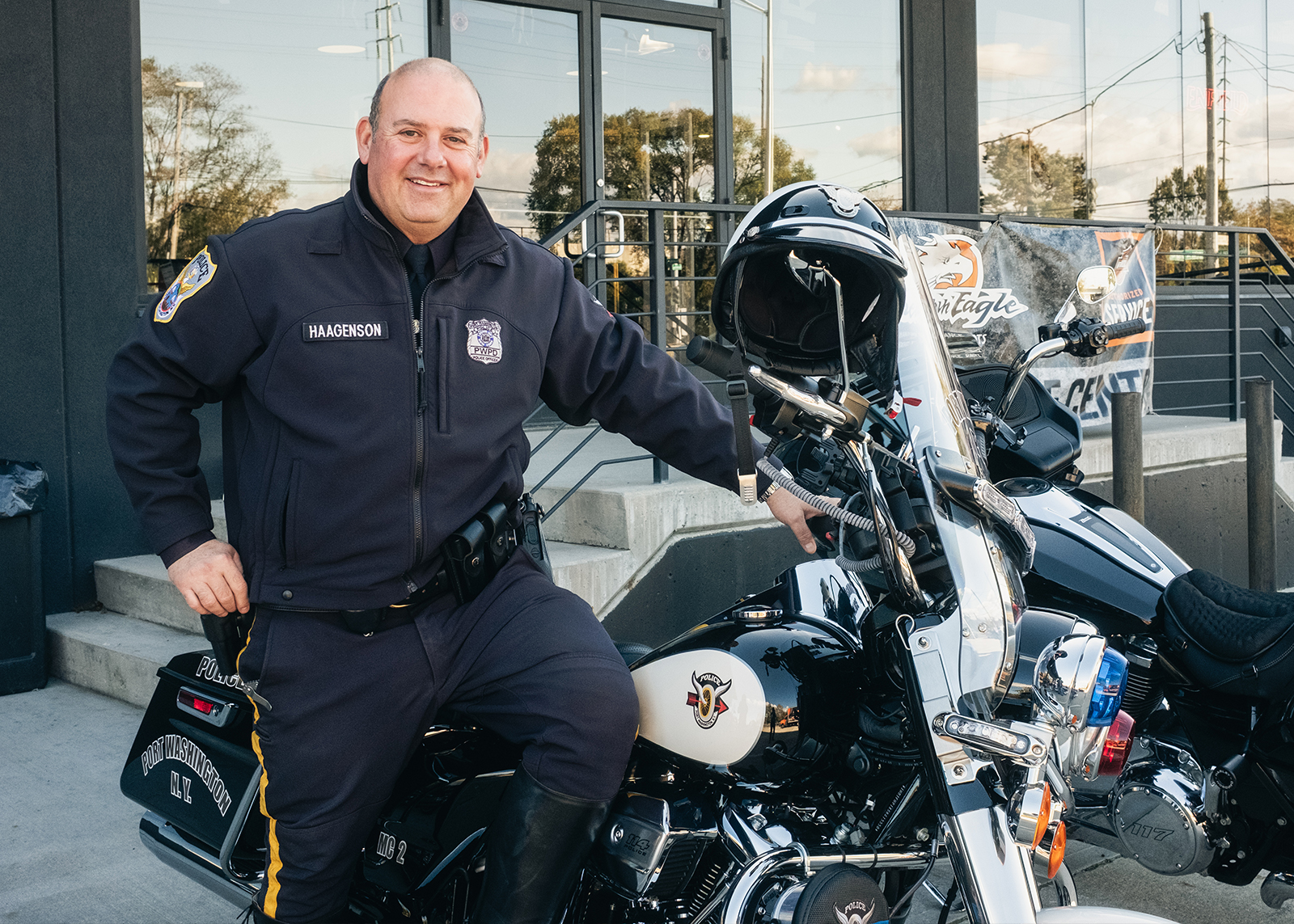 Police Motorcycle Officer Drew W. Haagenson poses for a photo standing next to his service bike.