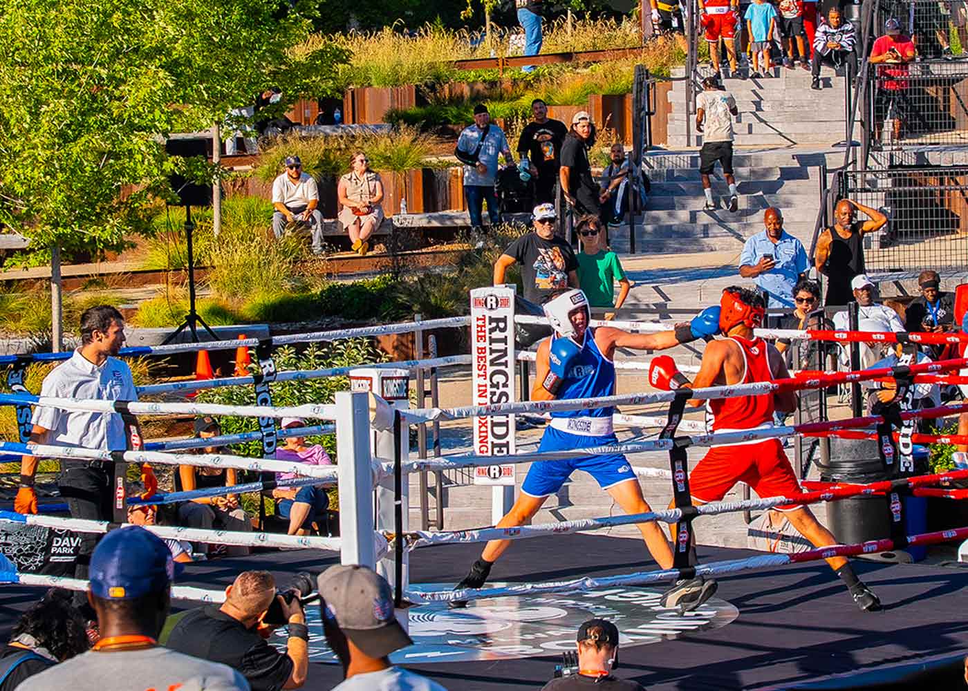Boxers competing in outdoor ring during Harley-Davidson boxing event