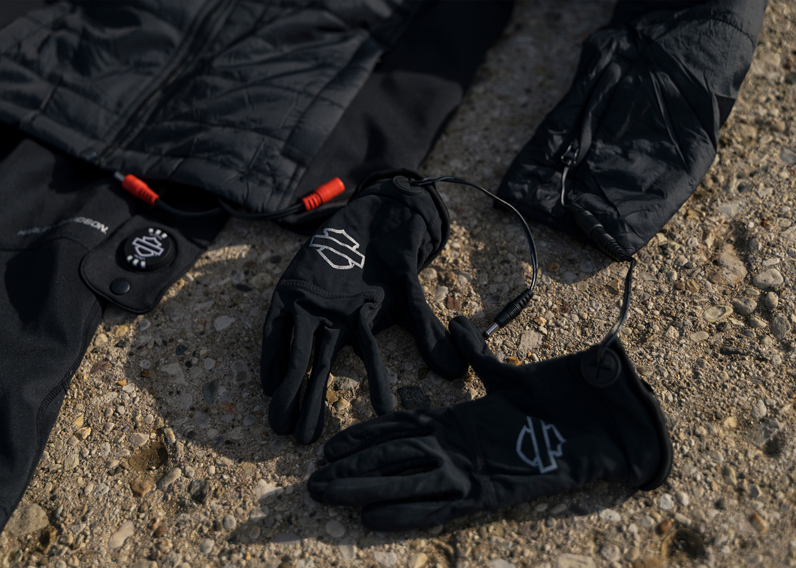 A close in shot of Harley-Davidson heated riding gloves plugged into the heated riding jacket