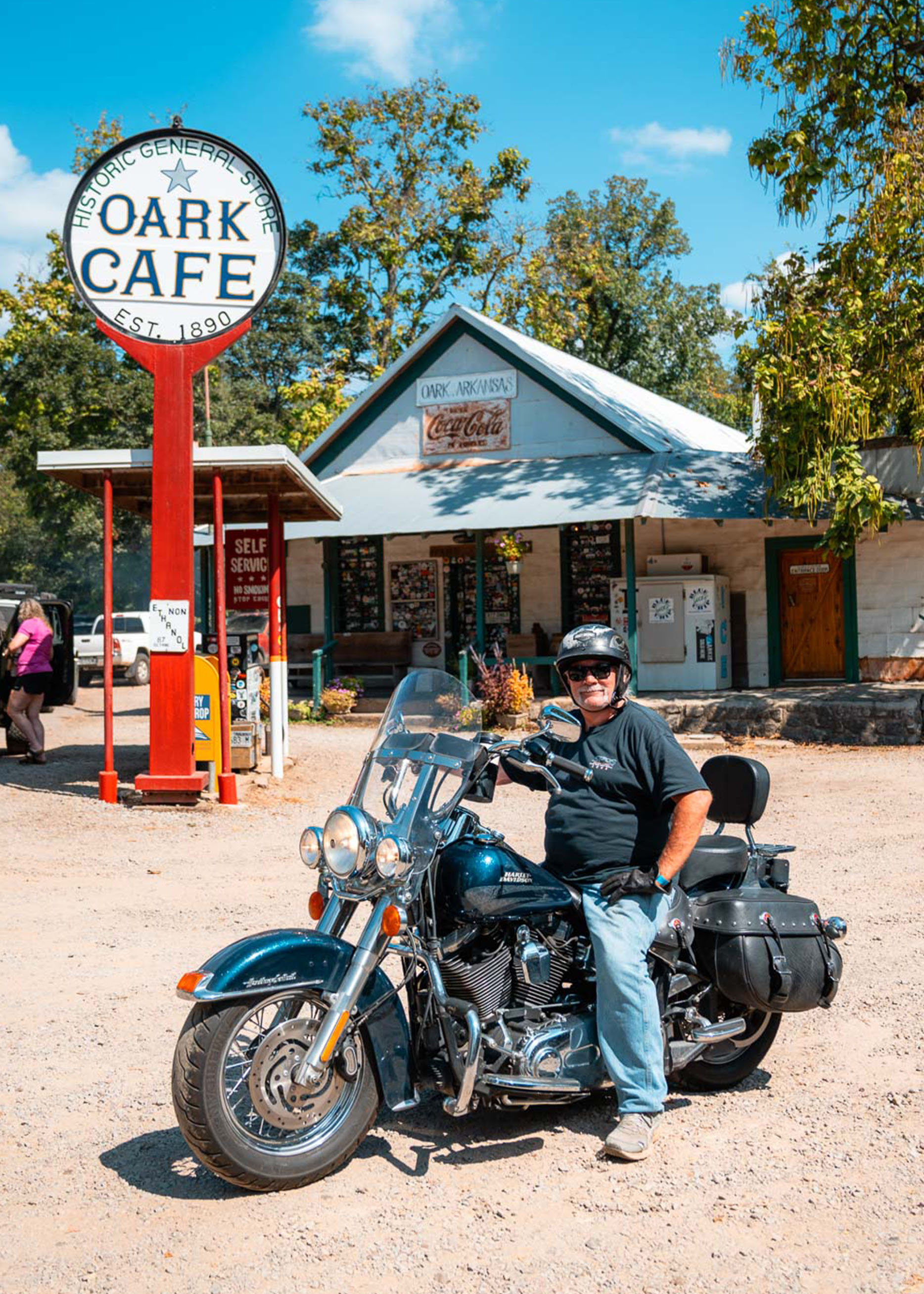 A man poses on his motorcycle in the parking lot of the Oark Cafe