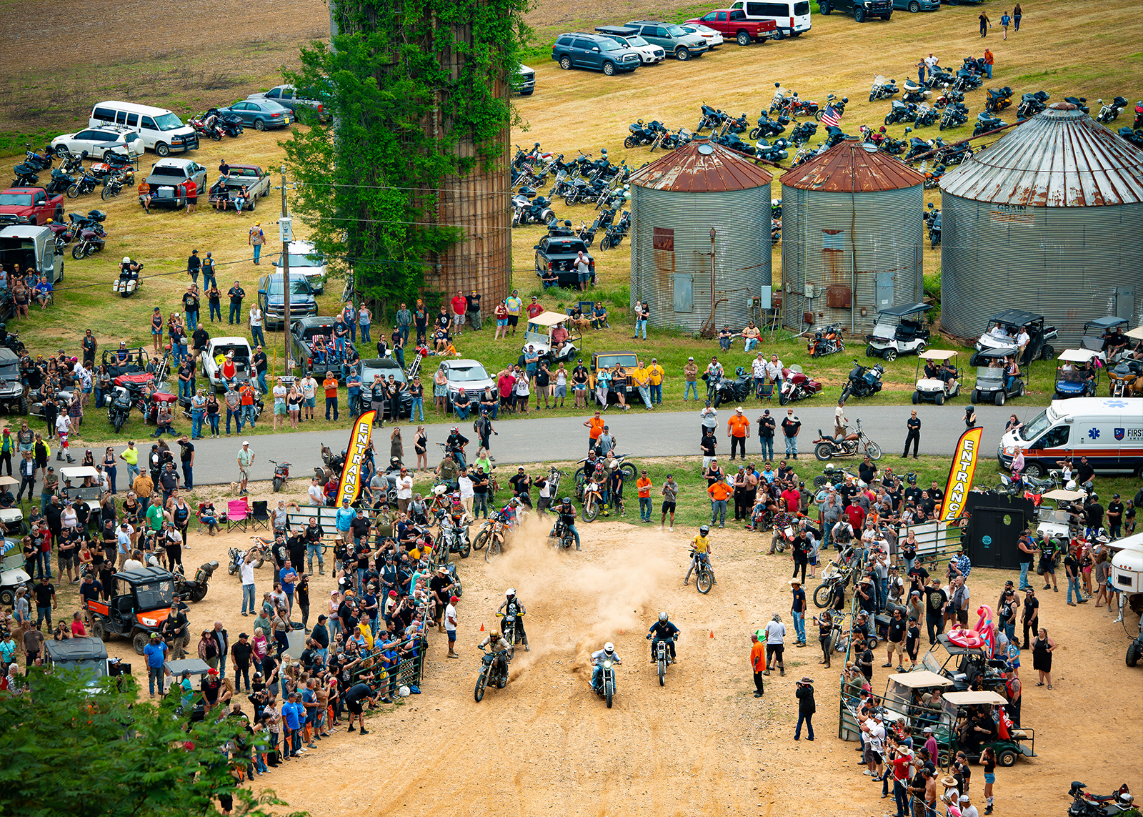 A large crowd gathered to watch a group of riders start a hill climb.