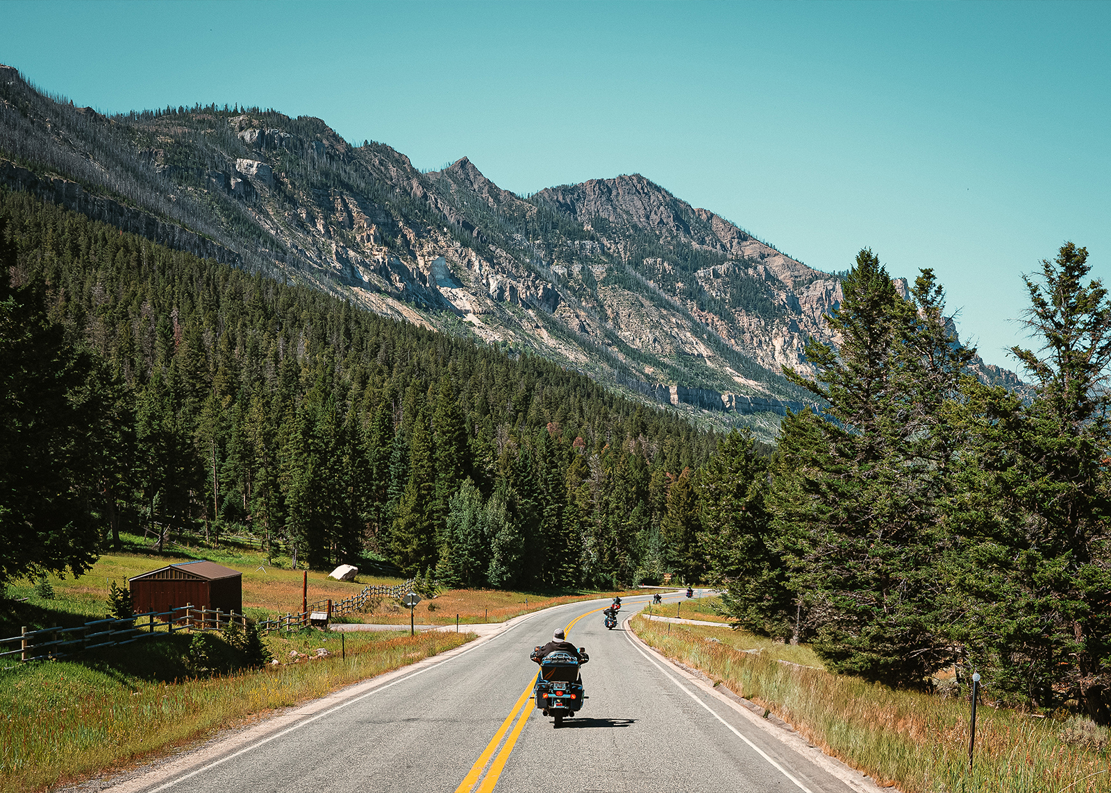 Motorcycles riding through a sweeping vista in Vanocker Canyon, South Dakota