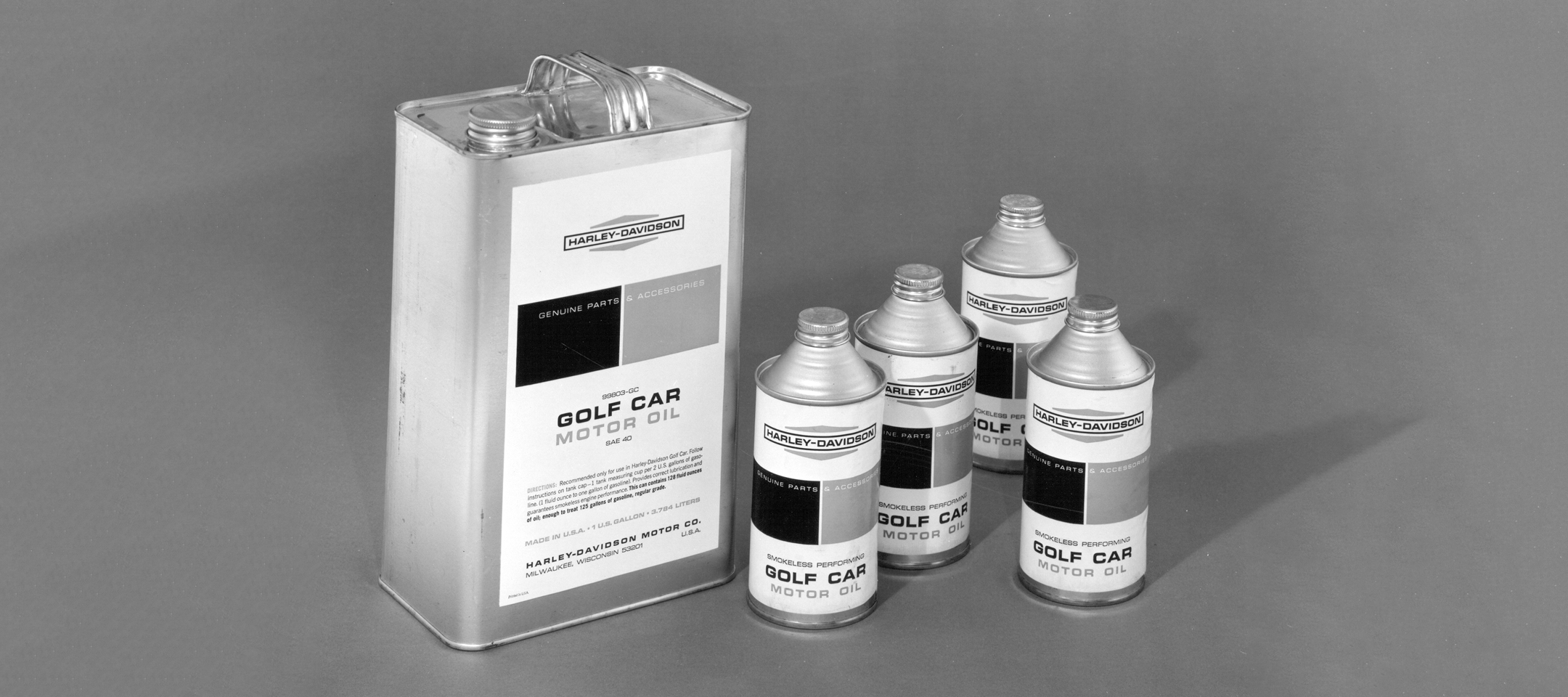Vintage Harley-Davidson golf car motor oil containers featuring the diamond logo used in the 1960s