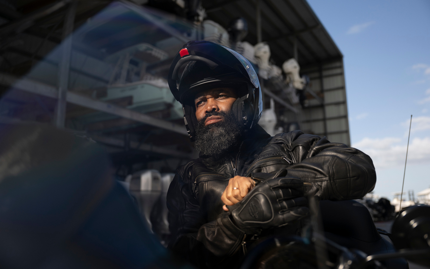 Person puts on gloves while wearing Auroral II 3-in-1 leather jacket