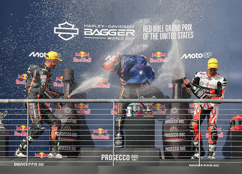Racers spray champagne on the podium during the first weekend of Bagger World Cup racing