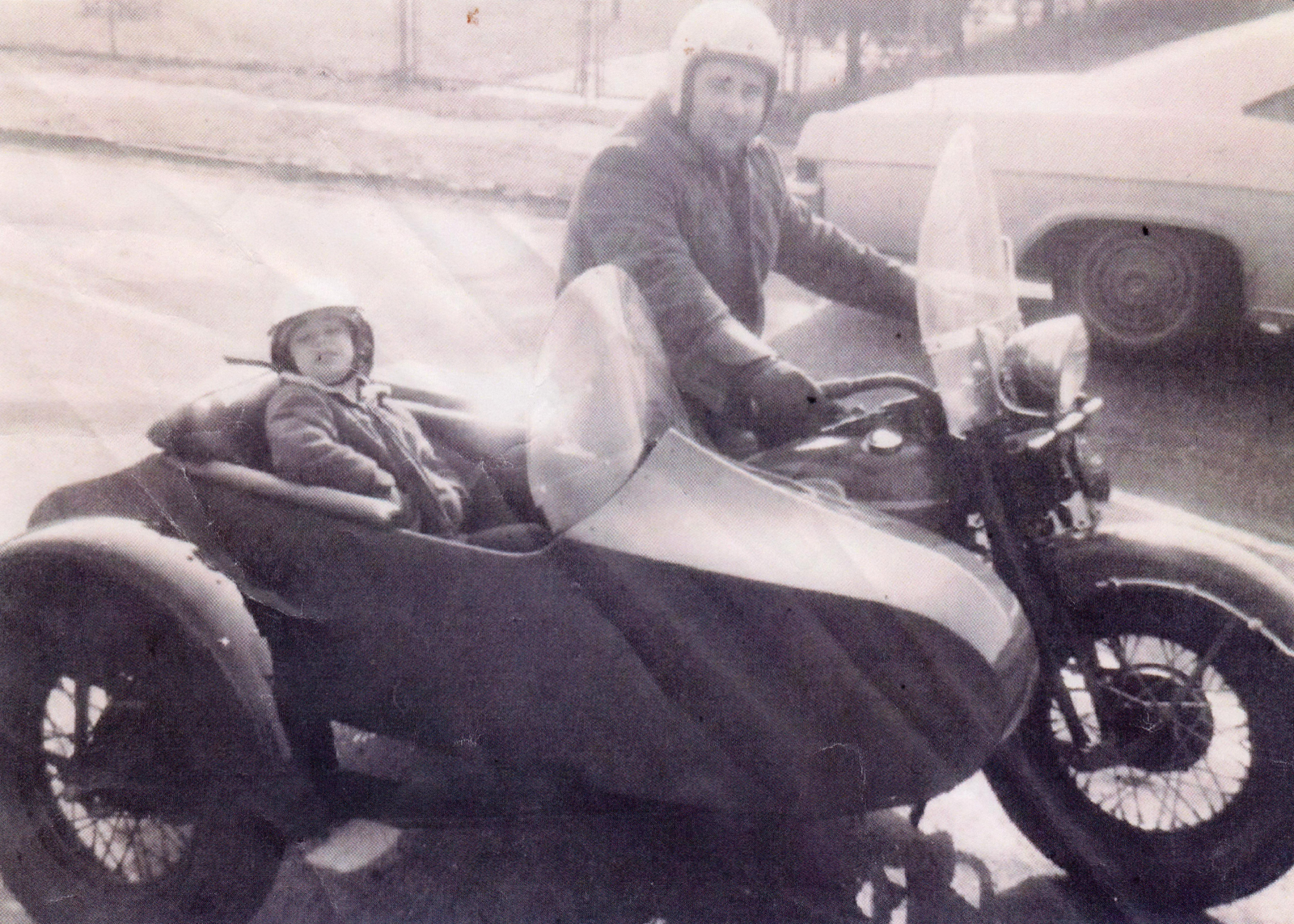 A vintage photo of Harley-Davidson of Nassau County founder Marty Altholtz driving a motorcycle with his son Larry in the sidecar.