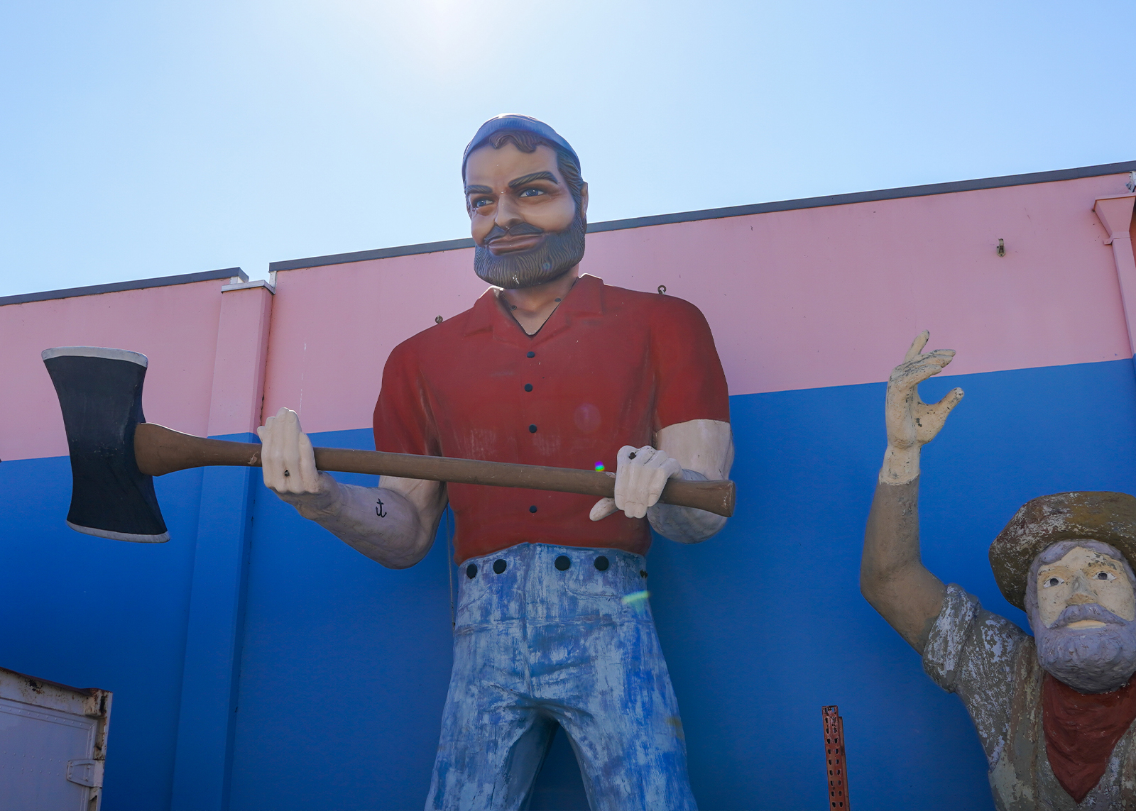 A roadside attraction featuring an oversized fiberglass statue of Paul Bunyan.