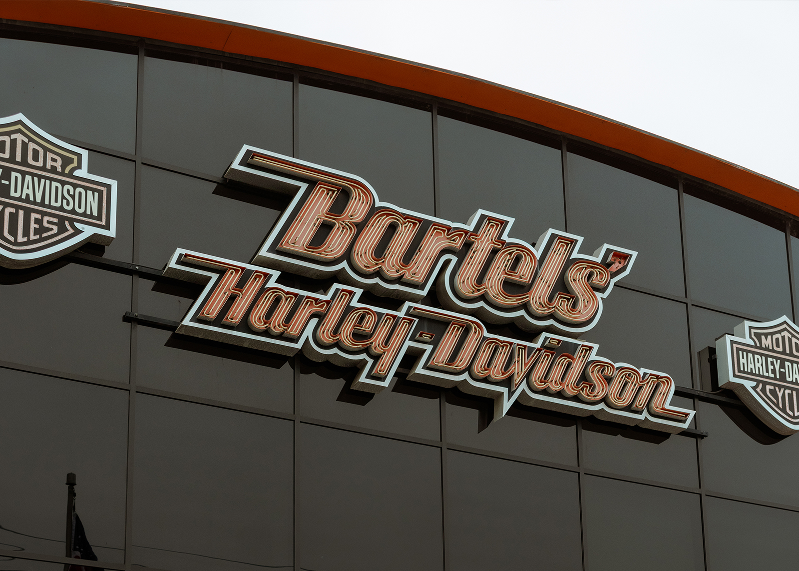 Bartel’s Harley-Davidson storefront with bikers and motorcycles out front.