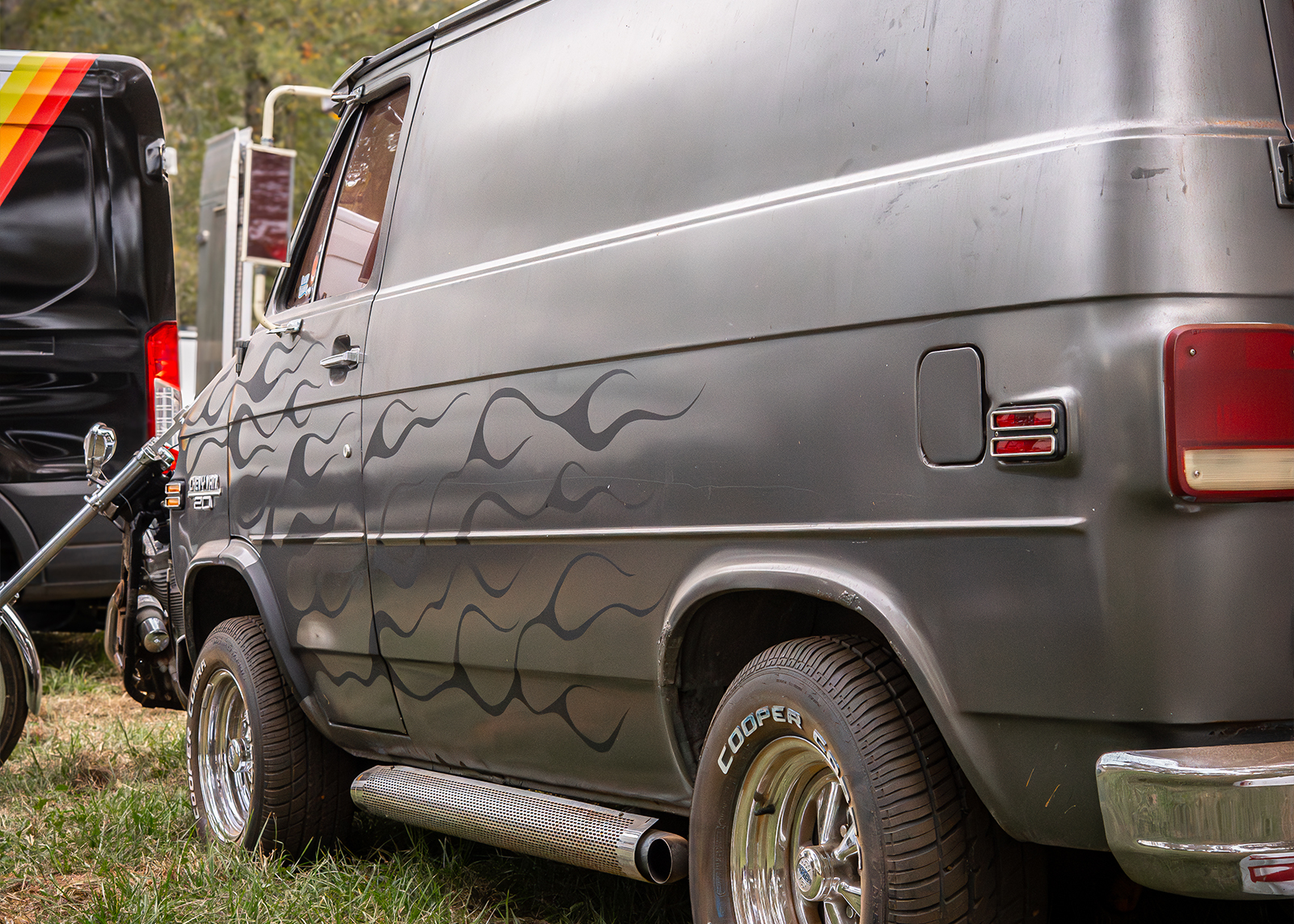 Gray van with black flames on the side
