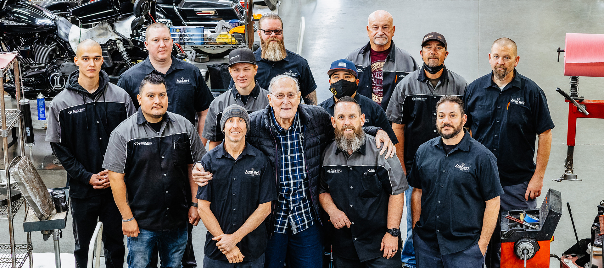 Bob Laidlaw surrounded by Laidlaw’s Harley-Davidson service staff.