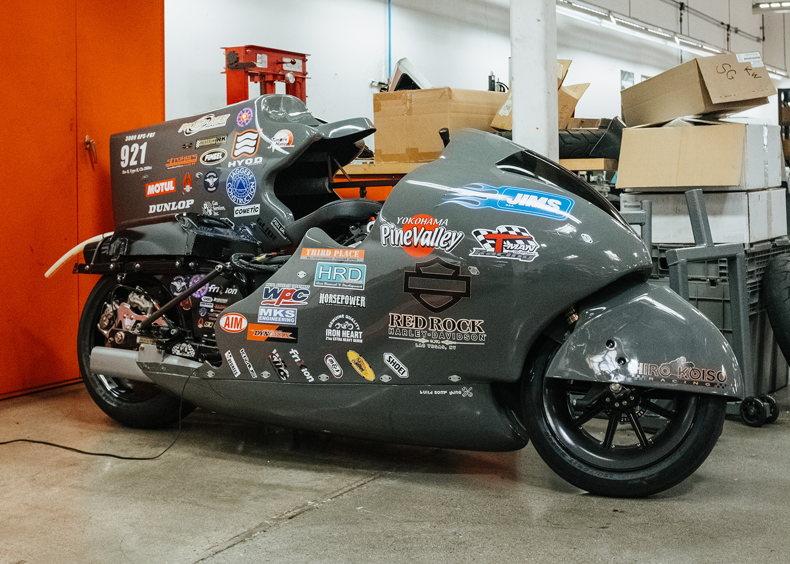 A motorcycle prepped for high speed with aerodynamic bodywork that is covered in racing stickers.