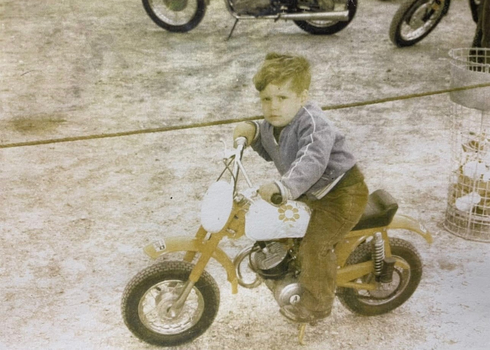 A childhood photo of Larry Altholtz riding a child-sized motorcycle.