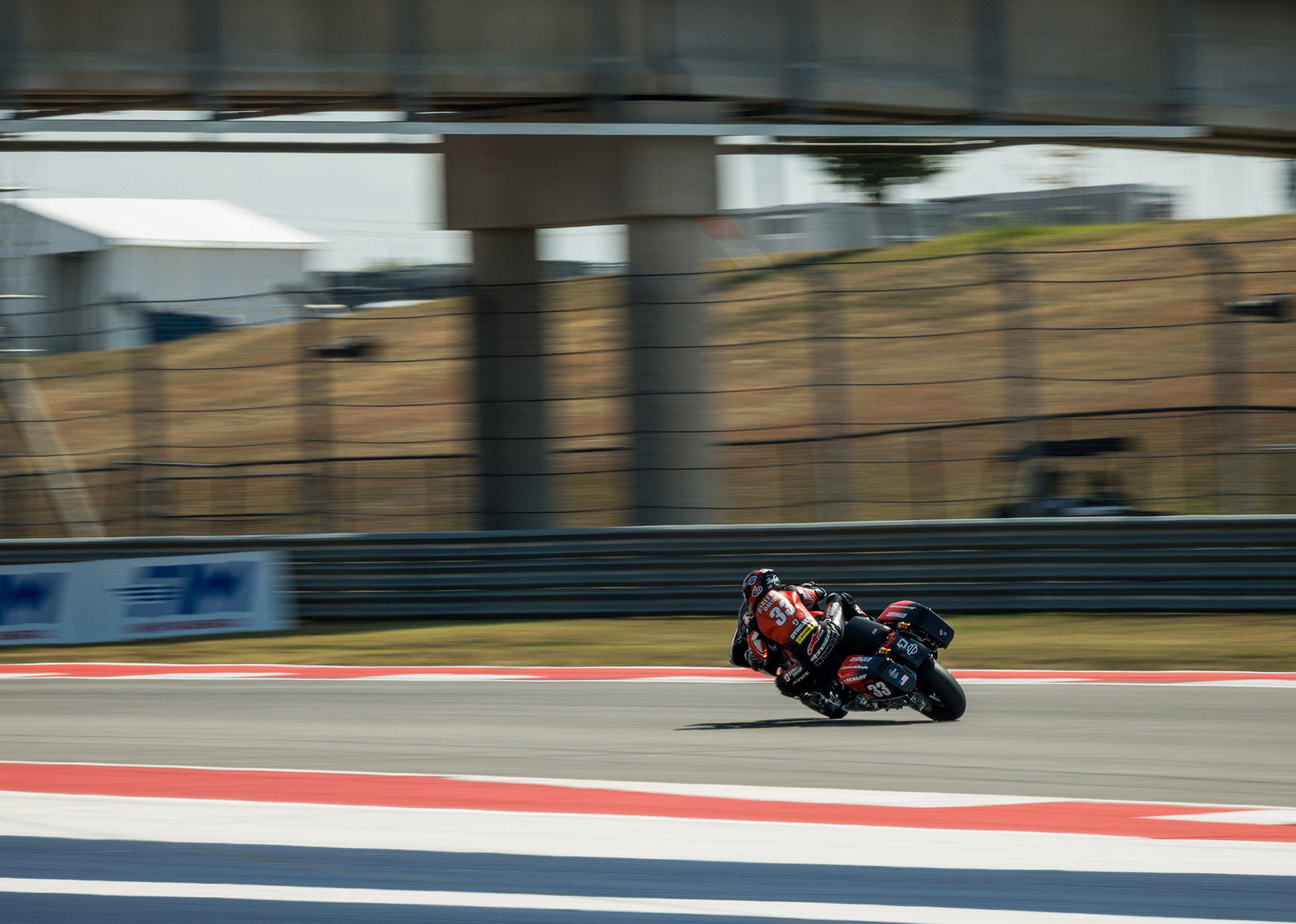 A wide shot of number 33 Kyle Wyman seen during a race riding away from the camera.