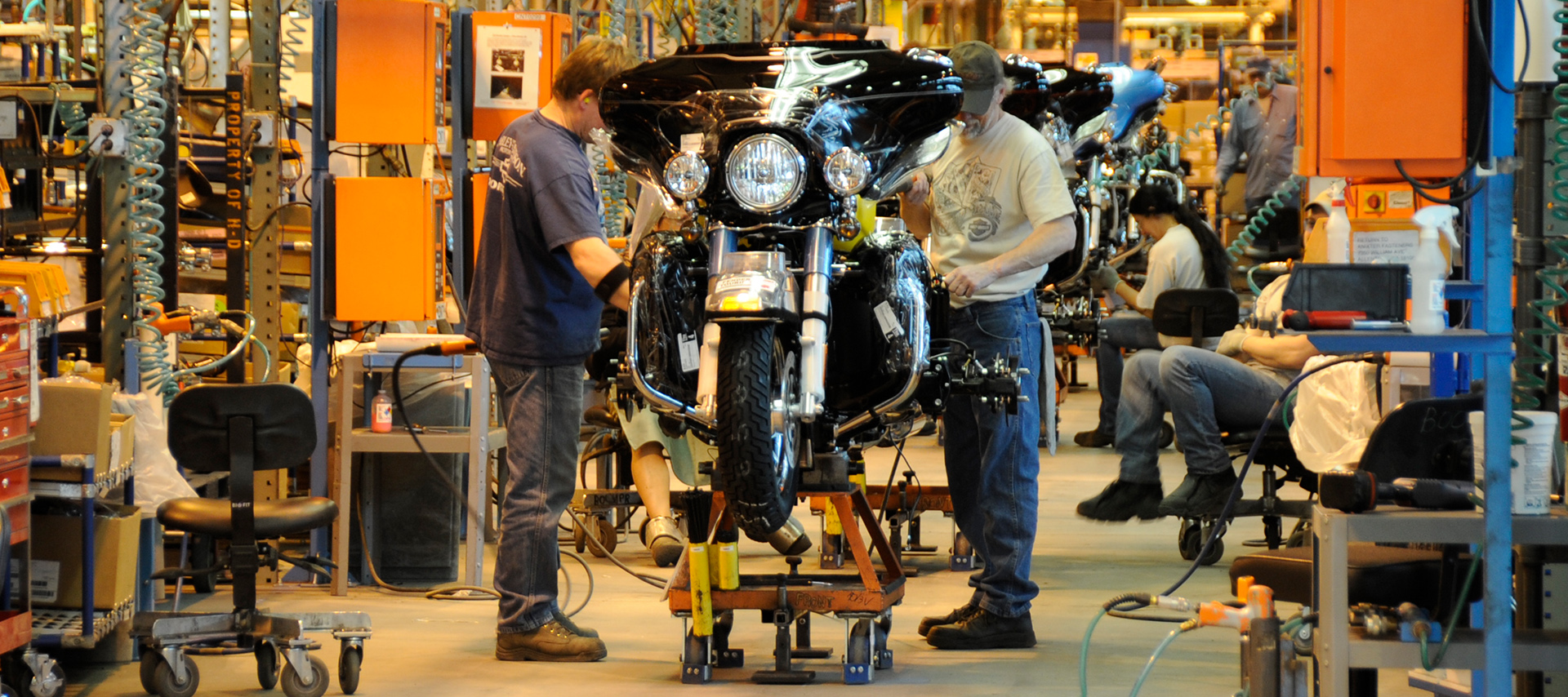 Motorcycle assembly line with workers building a bike