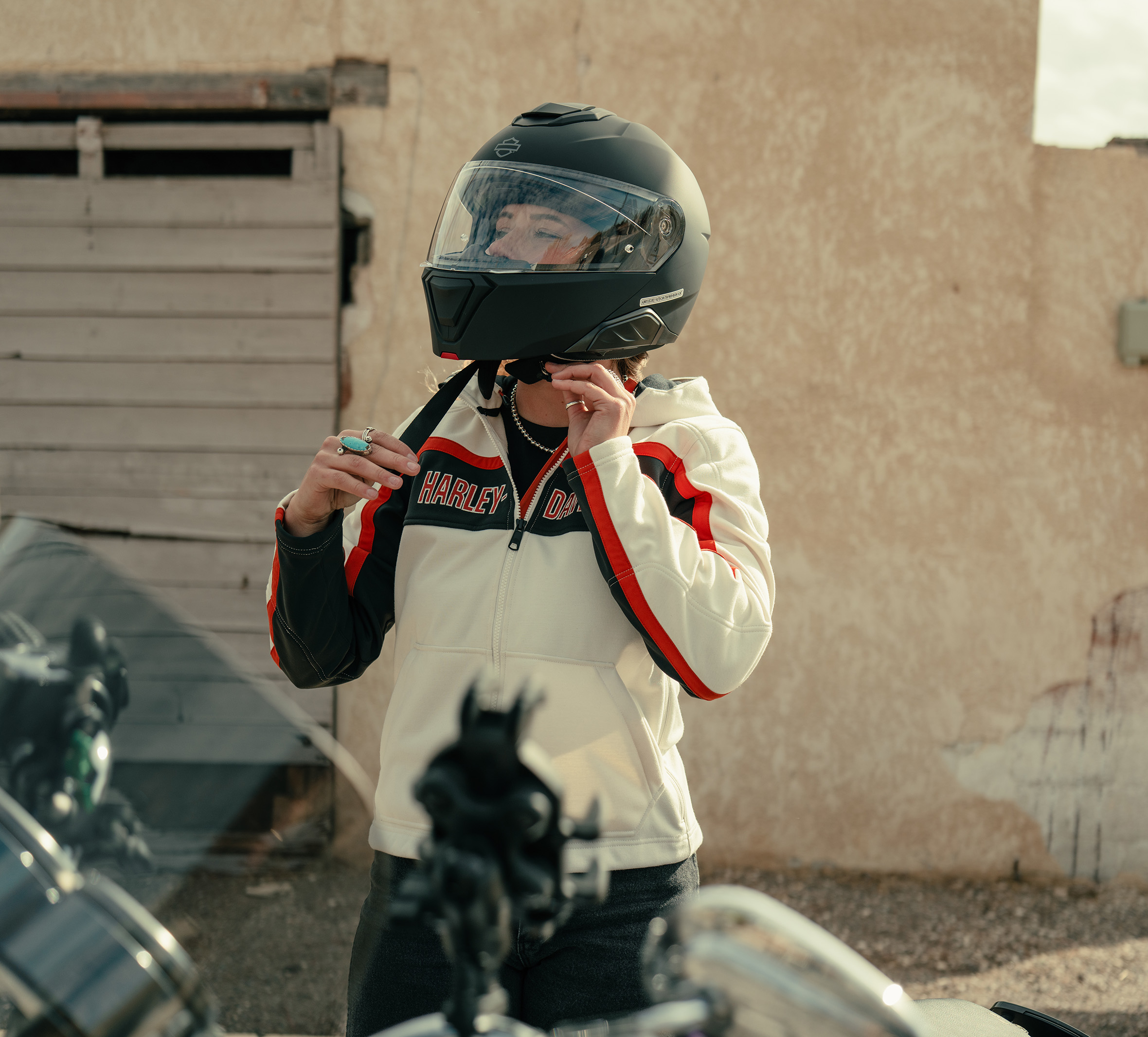 woman in motorcycle helmet and jacket 