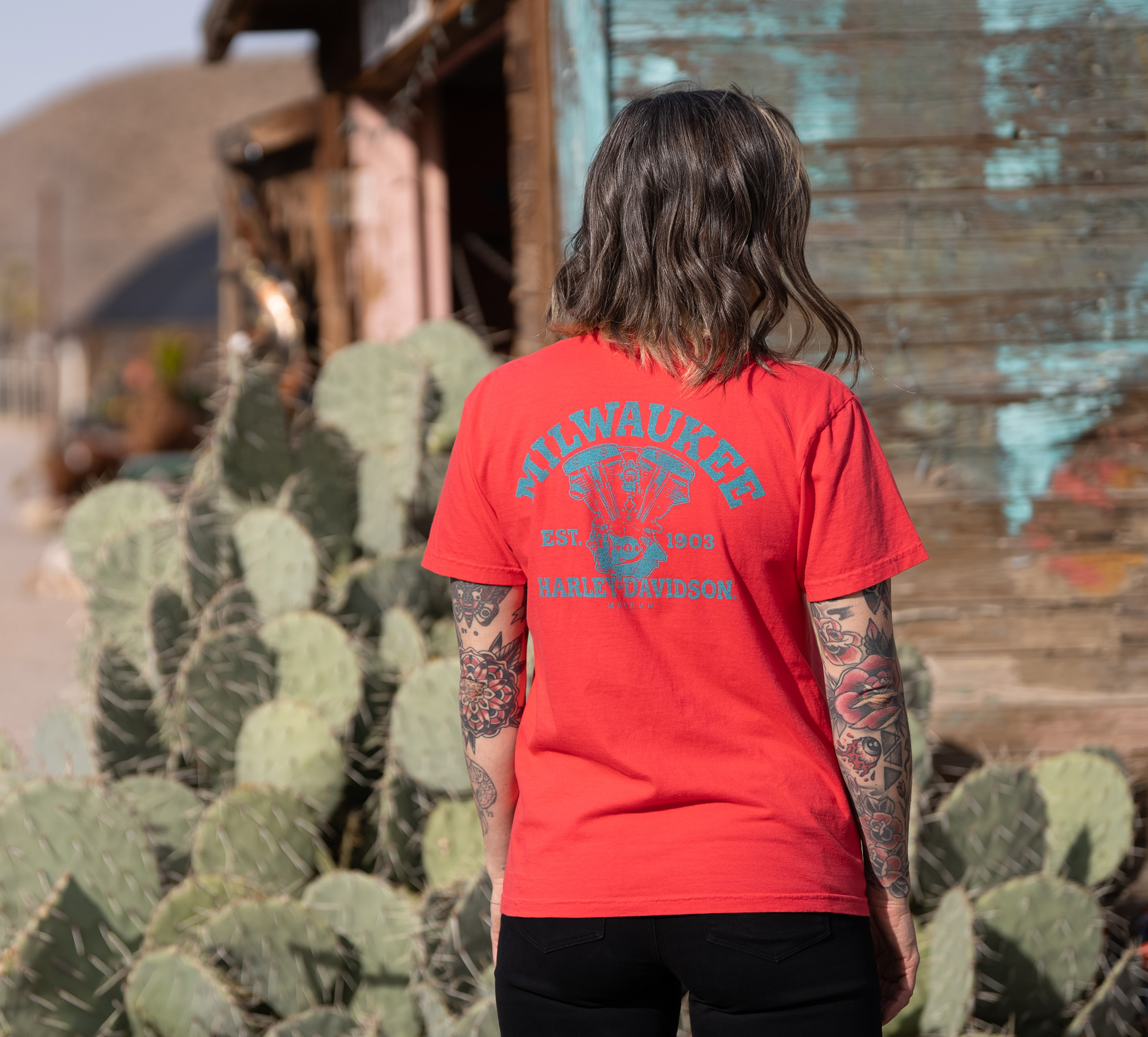 woman wearing pink short-sleeve tee with Milwaukee printed on back