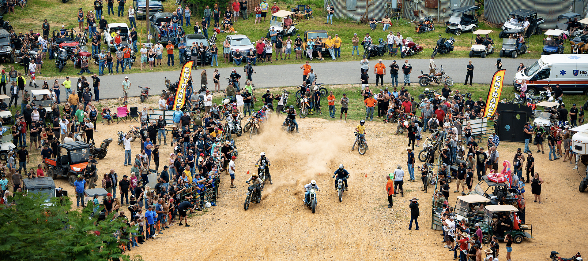 A large crowd gathered to watch a group of riders start a hill climb.