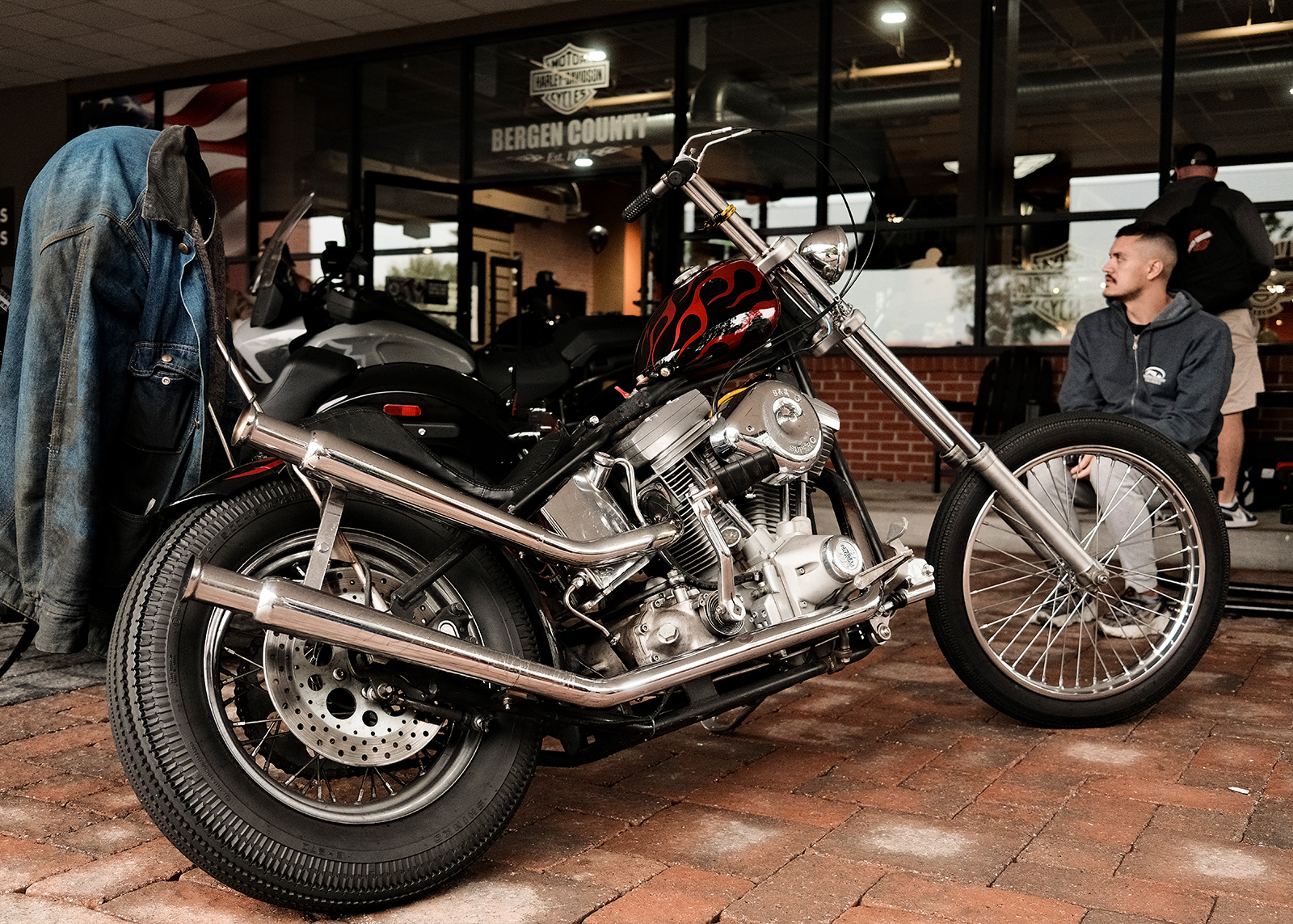 The authors custom-built chopper with a red flame paint job parked at the Bergen H-D 50 year anniversary party.