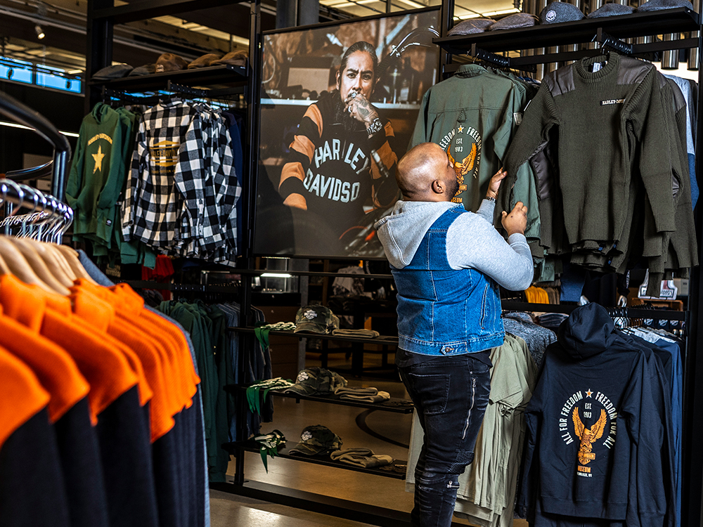 Shopper browsing Harley-Davidson clothing and merchandise in a retail store