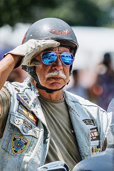Harley Davidson rider salutes a US service member 