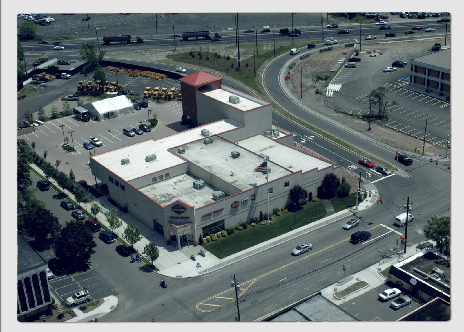 Aerial view of the large current day Bergen Harley-Davidson dealership building at a busy road intersection.