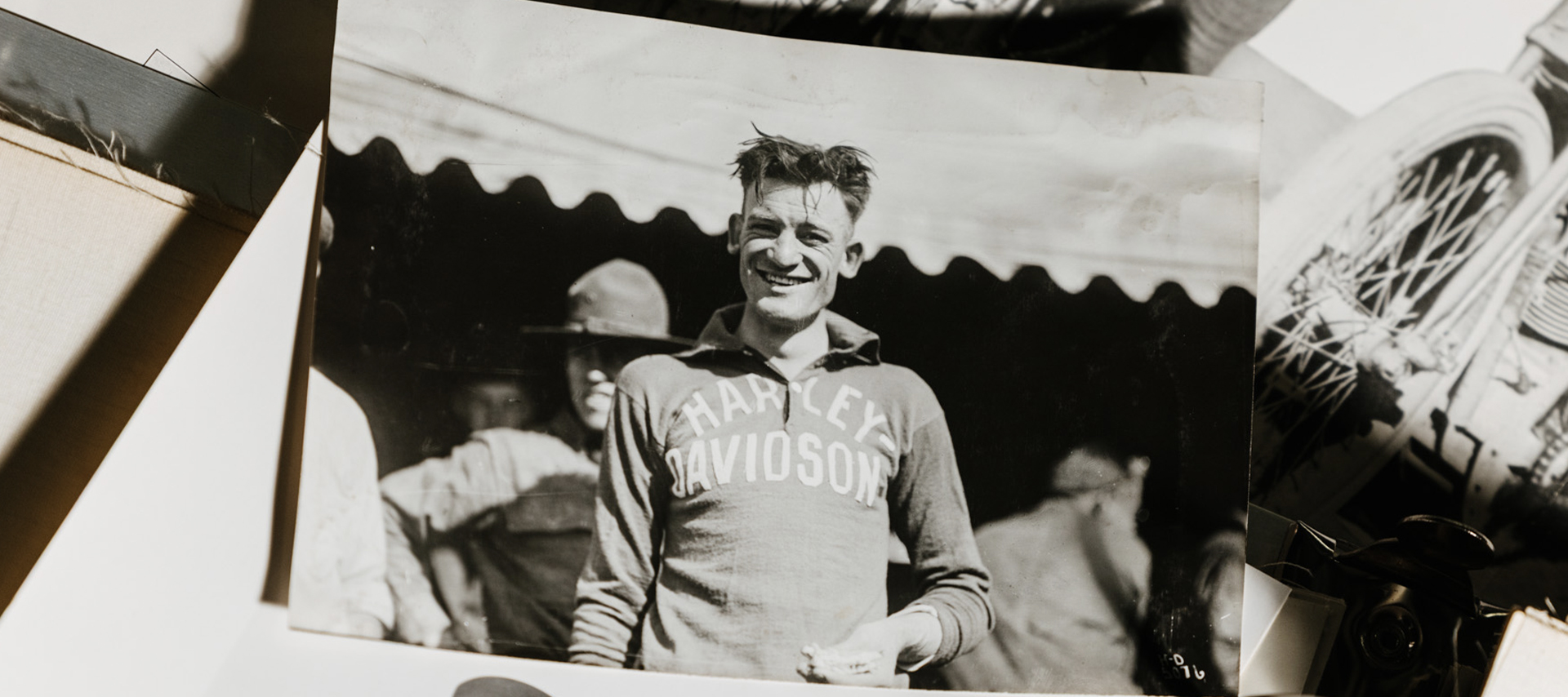 An old photograph of Red with disheveled hair in a Harley shirt.