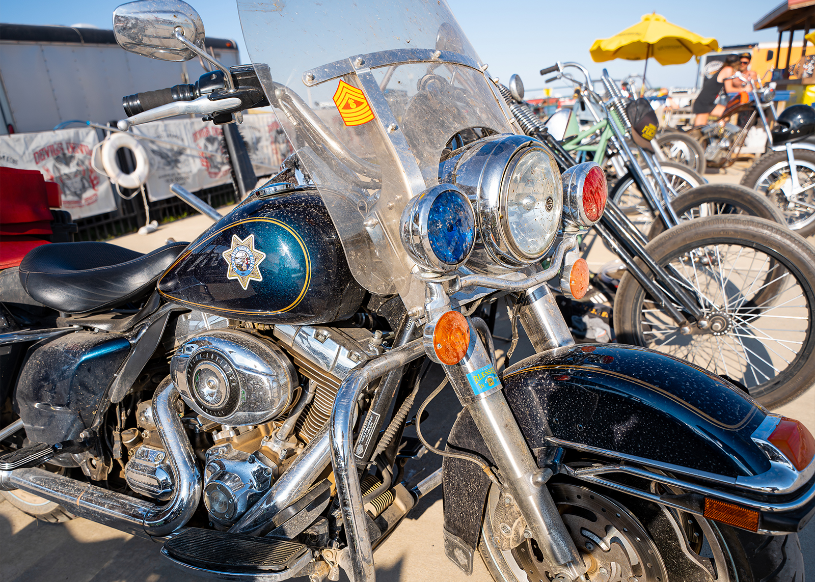 A dirty vintage Police bike is parked on a concrete pad 