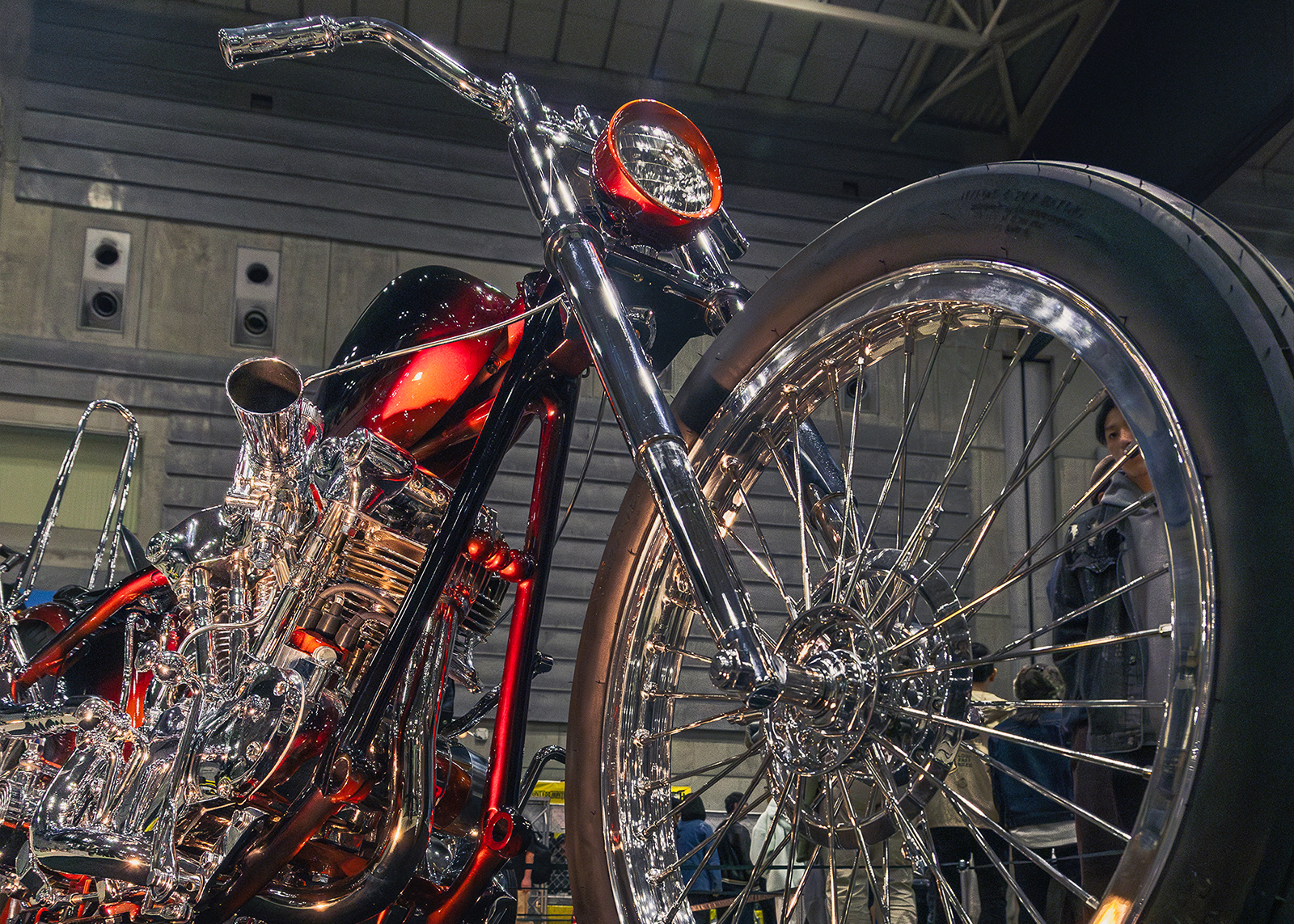 A ruby red and chrome custom chopper on display at the Mooneyes Yokohama Rod Custom Show